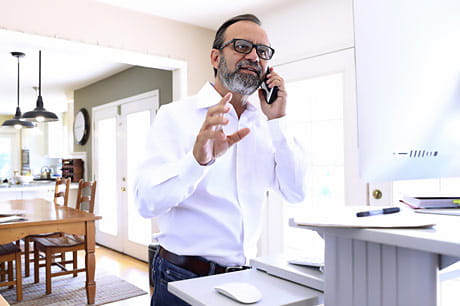 Man working from home at a standing desk.