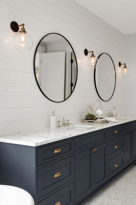 Bathroom in New Luxury Home with Two Sinks and Dark Blue Cabinets. Shows Walk-In Closet